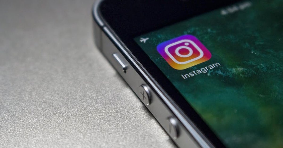 Close-up image of a smartphone screen displaying the Instagram app icon, emphasizing modern technology.