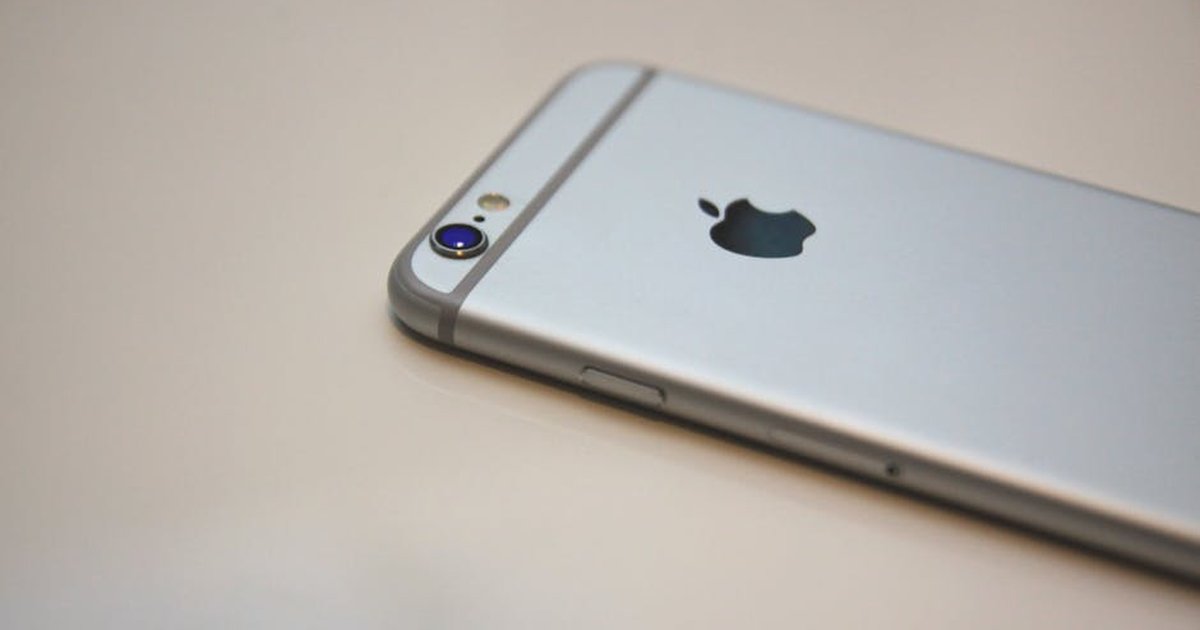 Closeup of silver smartphone showcasing camera and logo, perfect for technology and lifestyle themes.