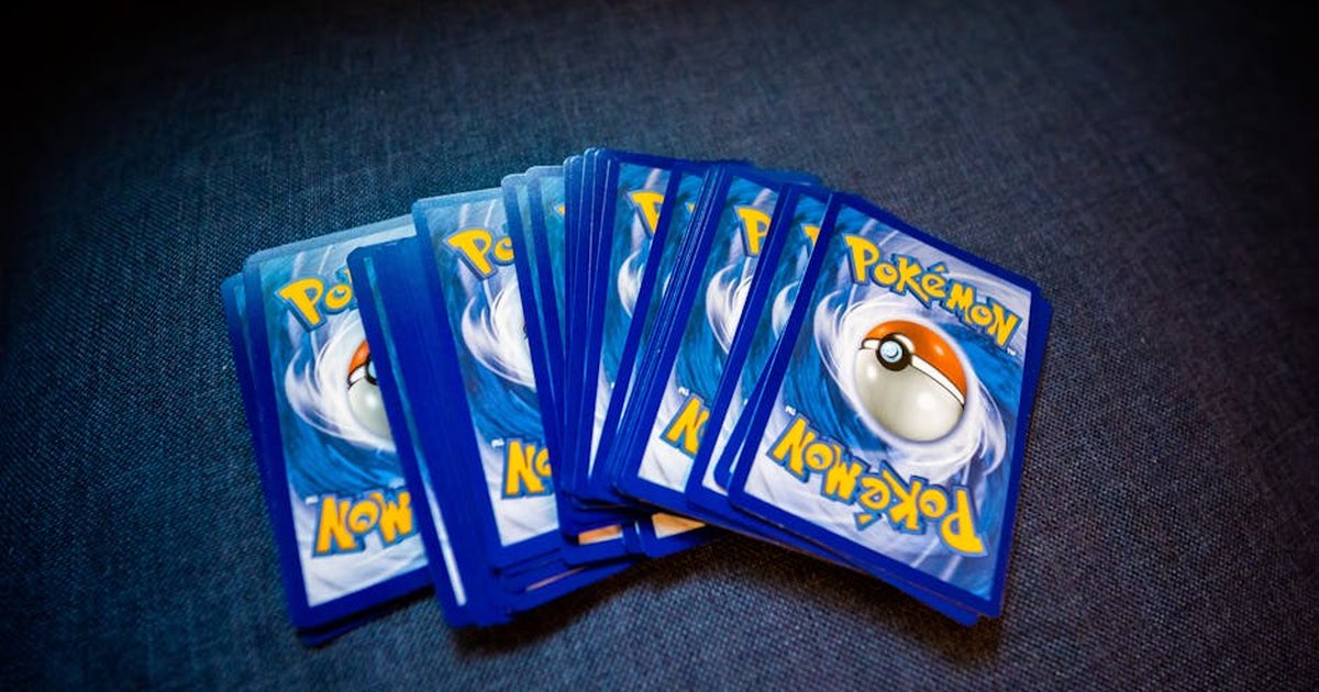 High angle of set of trading cards with images of fictional creatures placed against gray background