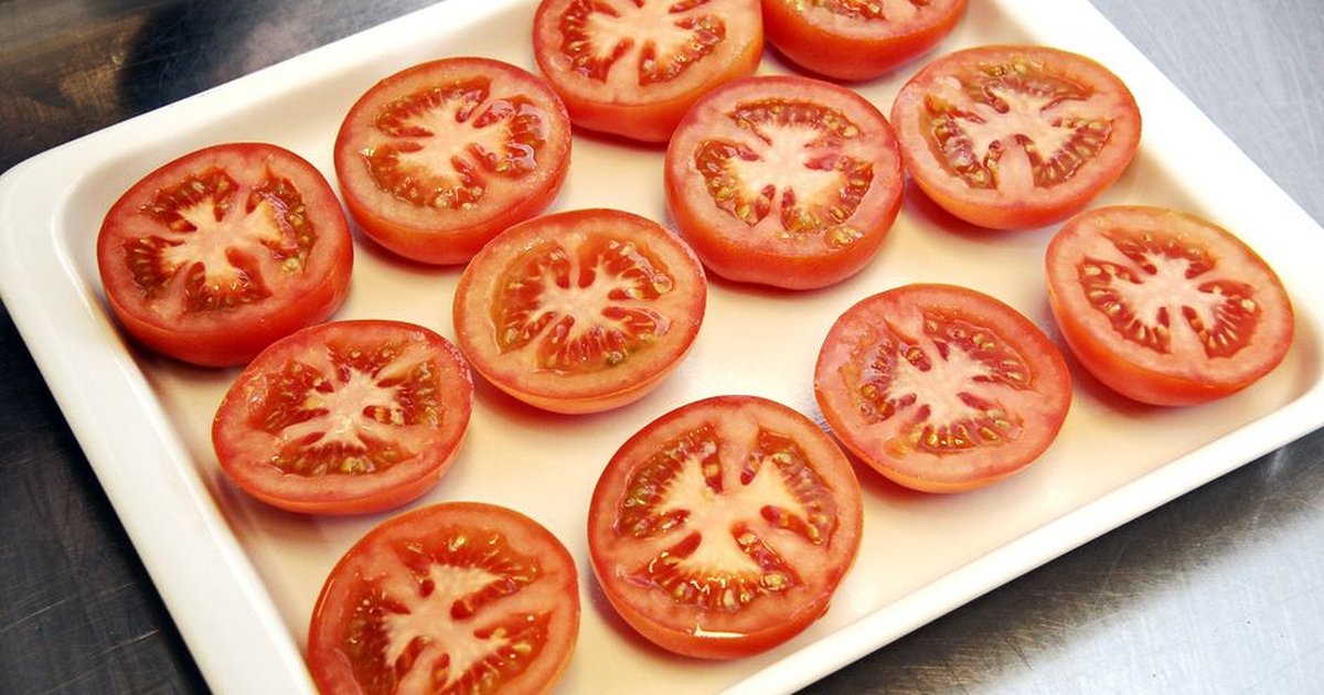 A plate of fresh tomato slices perfect for salads and healthy meals.