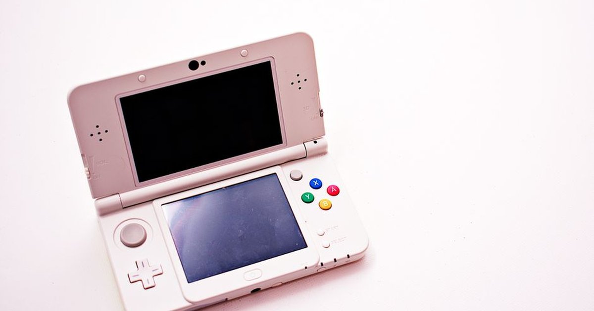 A clean shot of a white portable gaming console with two screens.