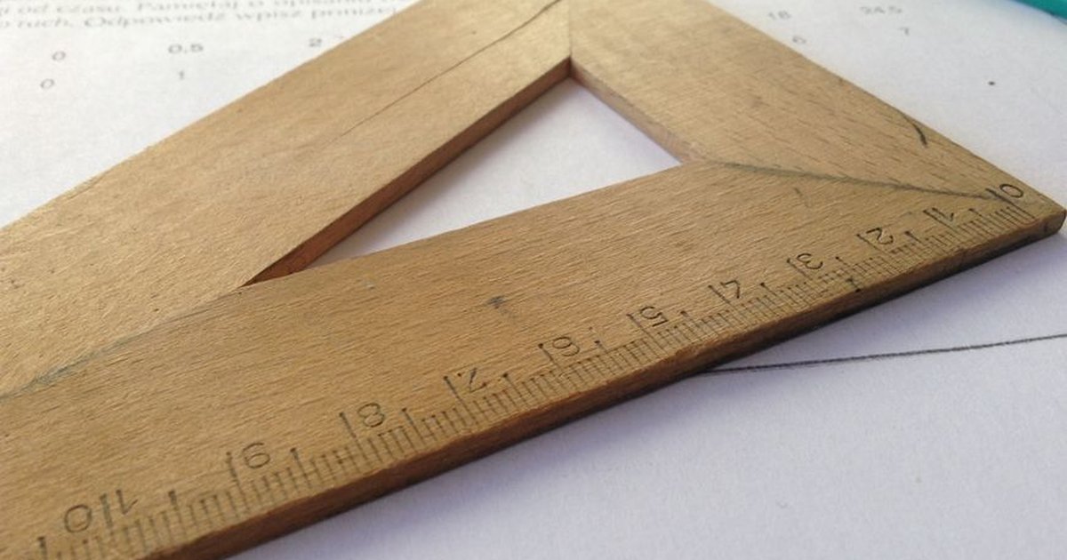 Close-up of a wooden ruler on paper, ideal for educational themes and measuring concepts.