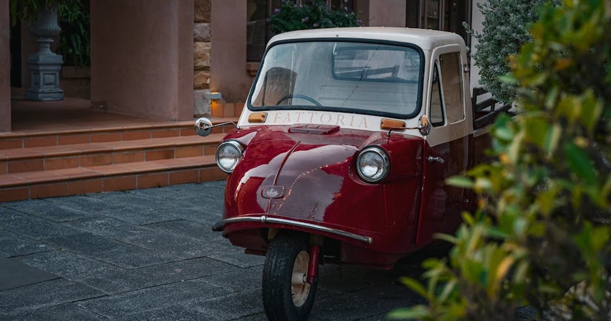 Charming retro three-wheeled vehicle in Thailand, captured outdoors in a serene setting.