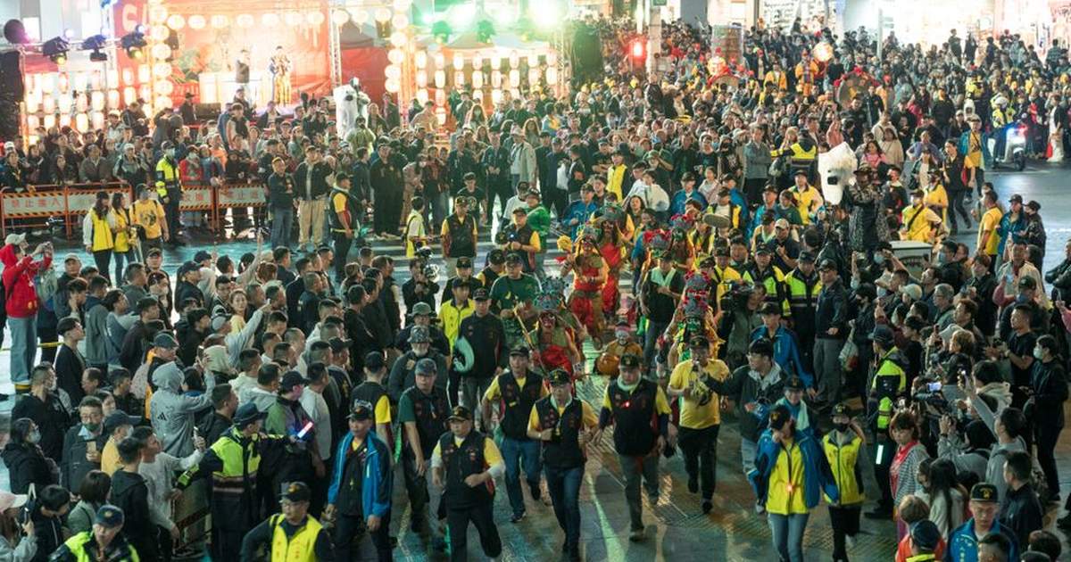 Crowds enjoy a colorful festival parade in the lively streets of Taipei, Taiwan.
