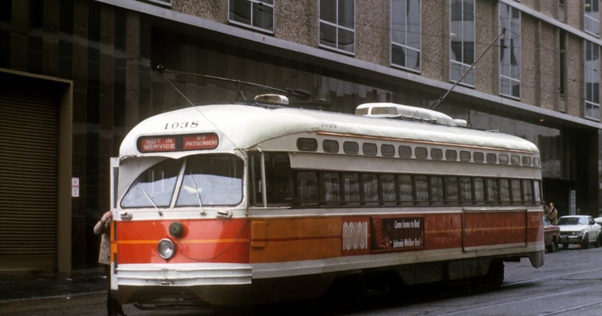 Classic streetcar on a rainy day in San Francisco, highlighting urban transit charm.