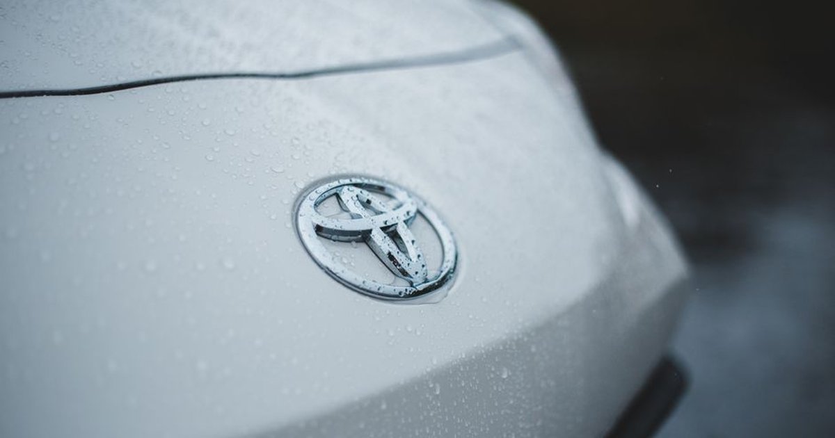 Closeup of silver wet automobile with logo and classic modern design in soft focus
