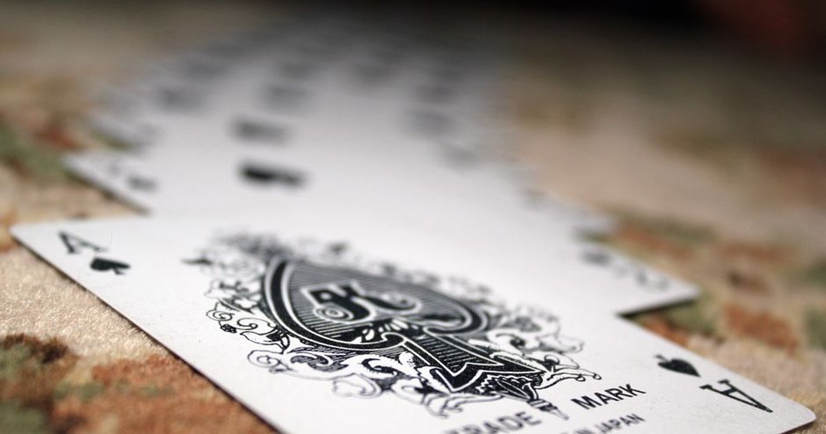 Close-up of Ace of Spades with a deck of playing cards, showcasing depth of field.