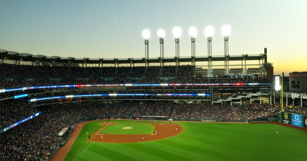 A vibrant twilight baseball game at Cleveland's Progressive Field, capturing the lively atmosphere.