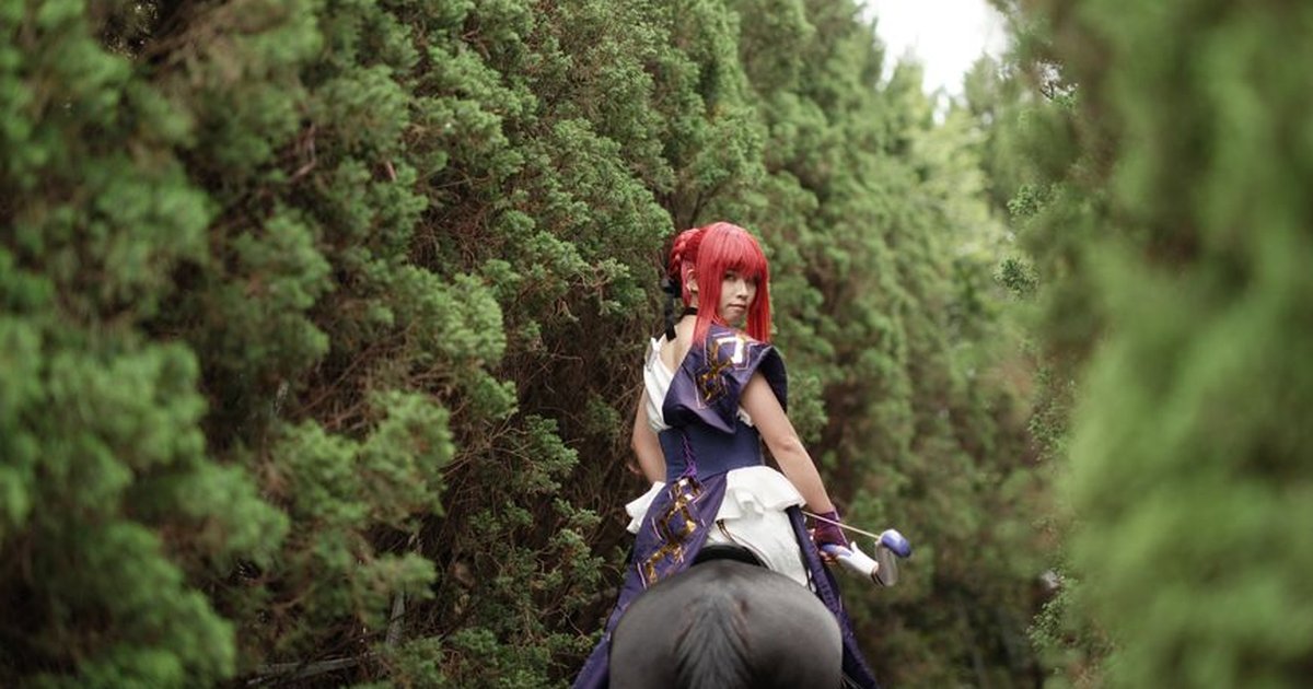 A person in cosplay riding a horse through a lush, green forest path. Captivating and enchanting.