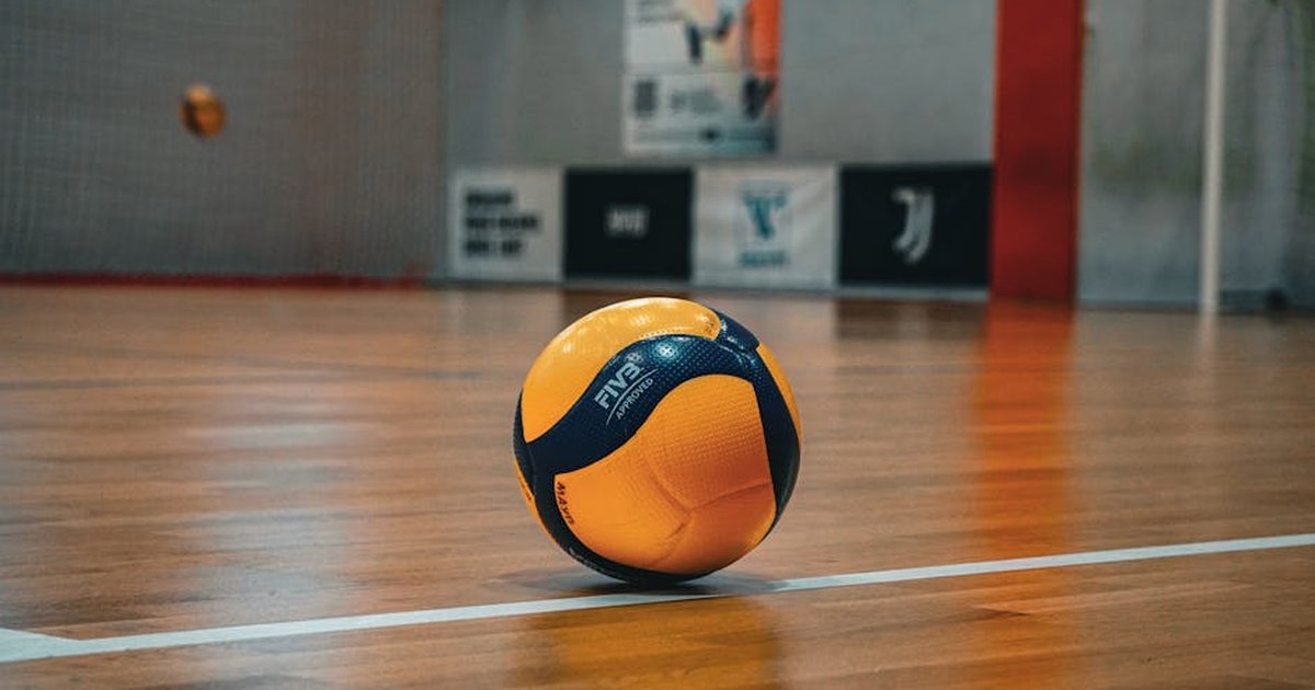 Volleyball resting on a polished indoor court in Kyiv, perfect for sport-themed imagery.