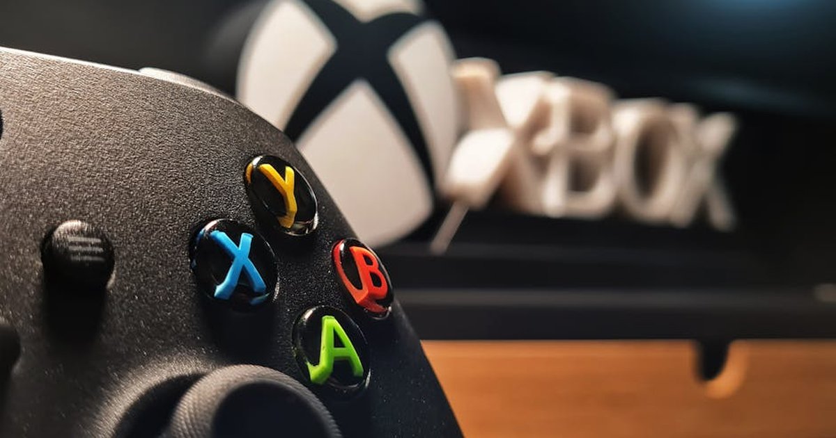 Detailed view of Xbox gaming controller with vibrant buttons displayed indoors.