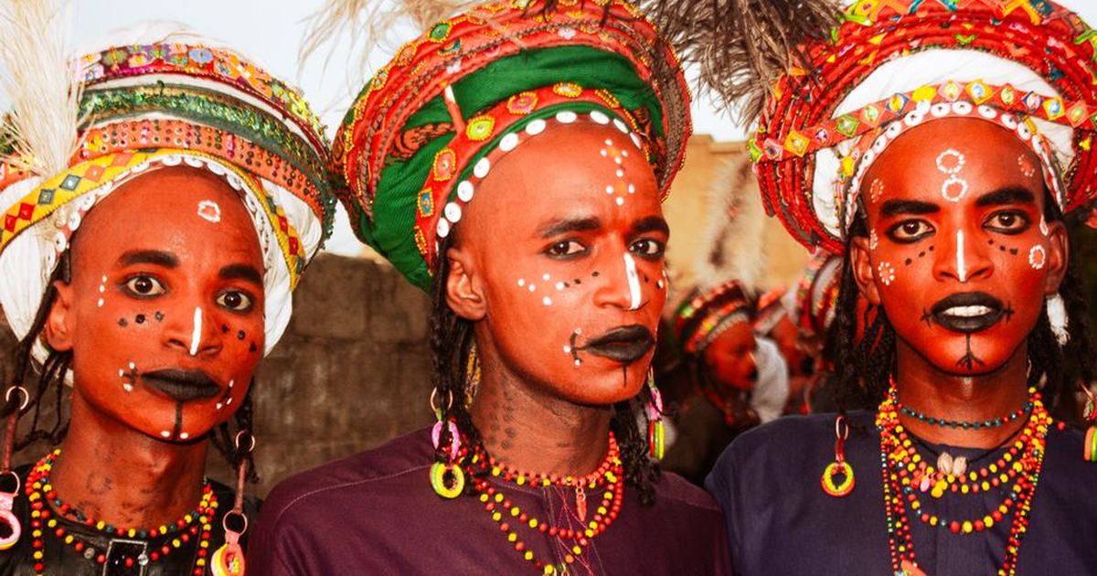 Vibrant portrait of individuals in traditional African attire at a cultural festival.
