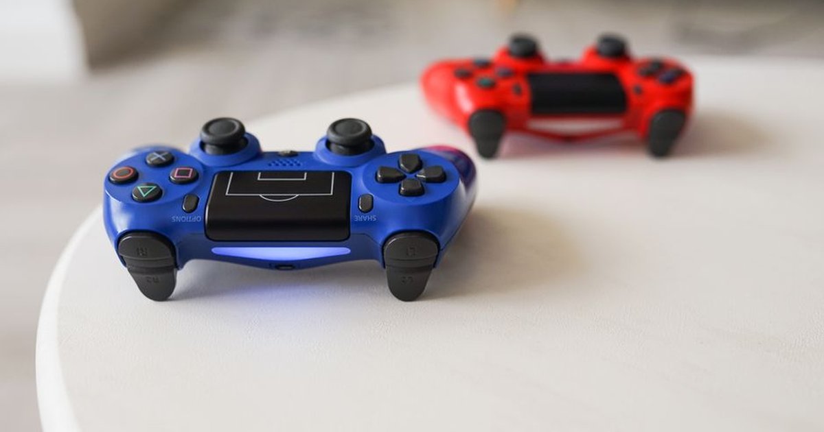 Close-up of PlayStation controllers on a white table for gaming enthusiasts.