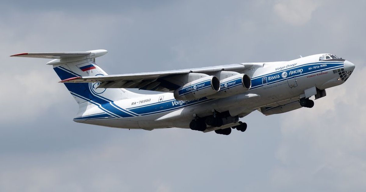 Close-up of a Volga-Dnepr cargo aircraft, Ilyushin Il-76, in flight on a cloudy day.