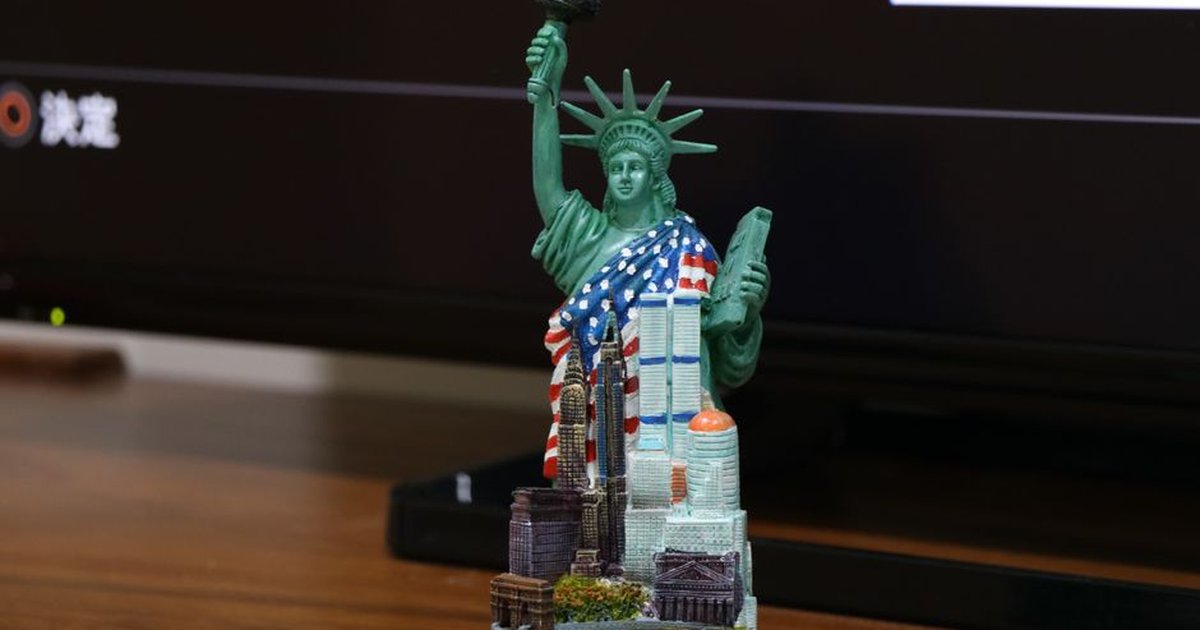 Close-up of a miniature Statue of Liberty figurine as a decorative piece.