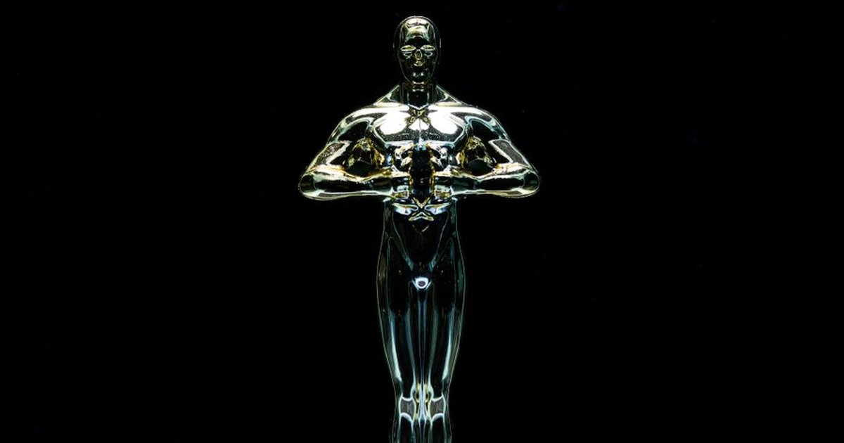 A golden trophy statue isolated on a black background symbolizing achievement and victory.