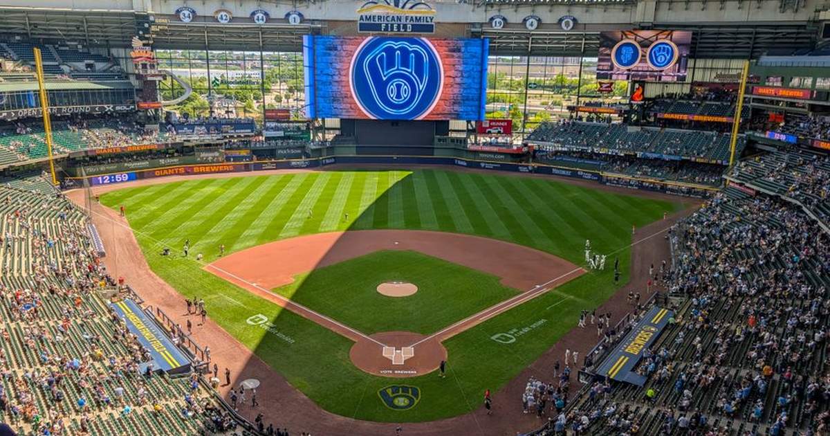 Aerial shot of American Family Field in Milwaukee during a daytime baseball game with clear skies.