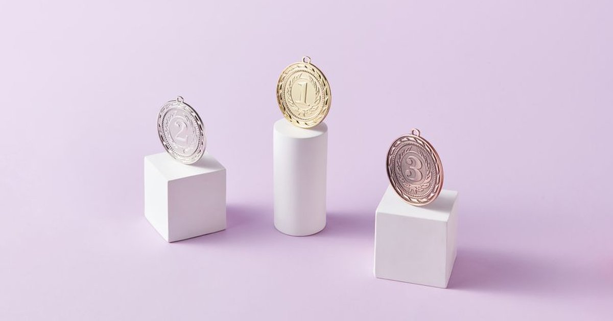 Three medals on podium blocks symbolizing first, second, and third place awards.
