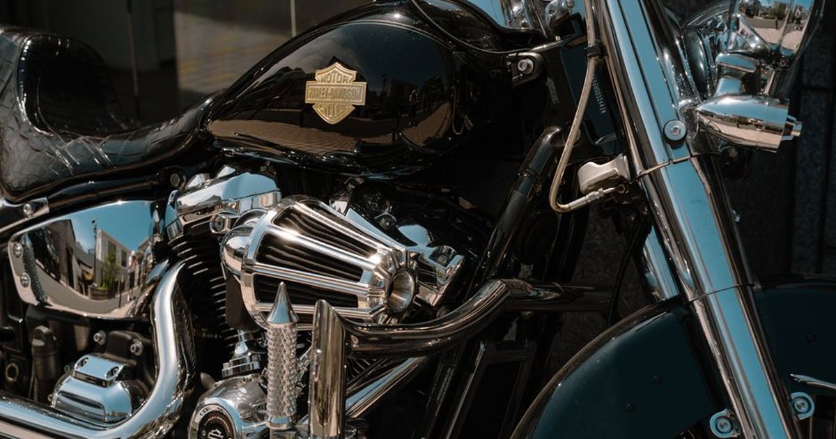 Detailed view of a chrome motorcycle engine under sunlight in Tokyo, Japan.
