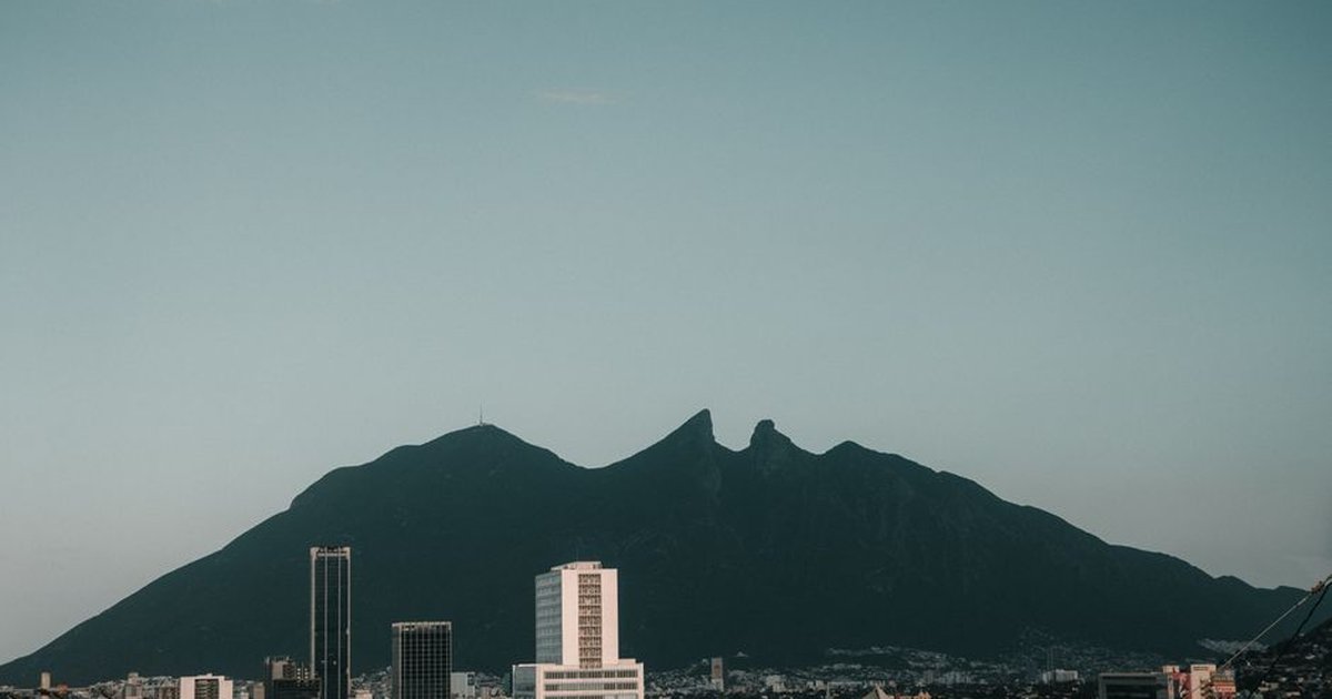 A stunning view of Monterrey cityscape with the iconic Cerro de la Silla mountain in the background.
