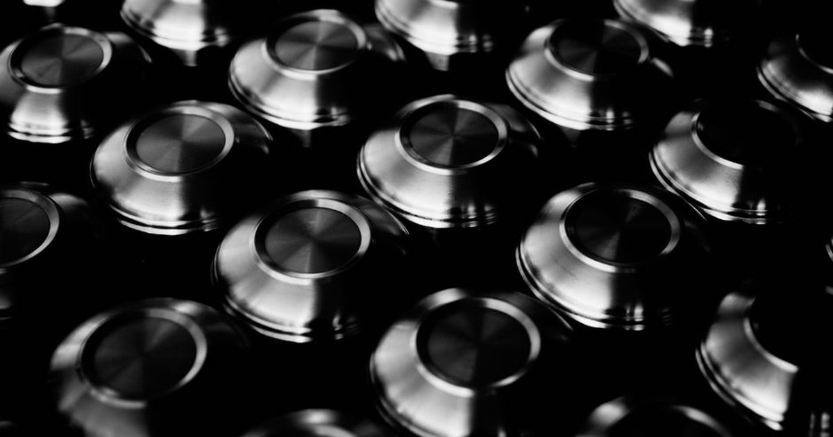 Artistic black and white photo of metallic bowls creating an abstract geometric pattern.