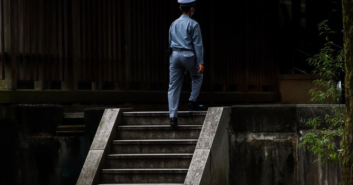 A security officer in uniform ascends steps, showcasing professionalism and duty.
