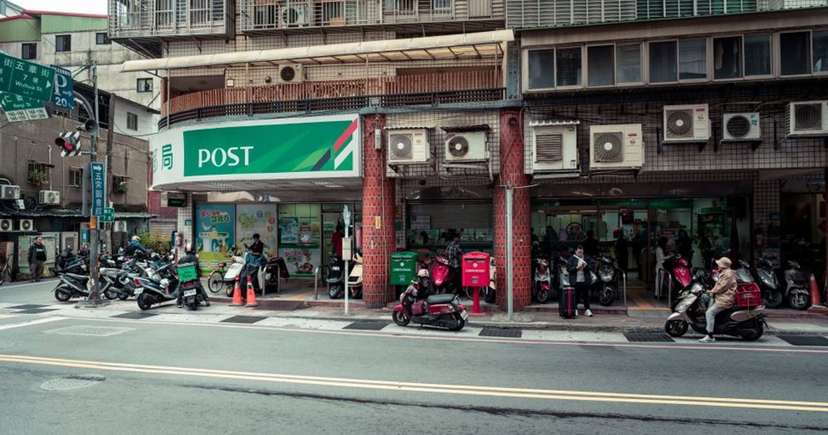 Vibrant street scene outside a post office in Taipei, Taiwan showcasing daily life.