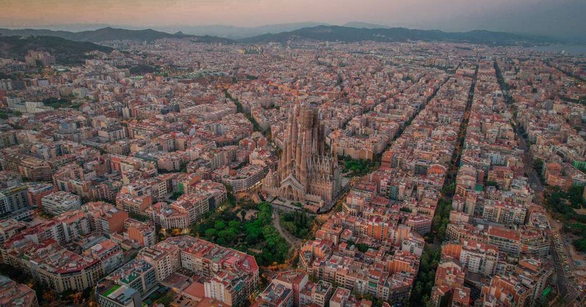 Aerial view of Barcelona with the iconic Sagrada Familia at sunset.