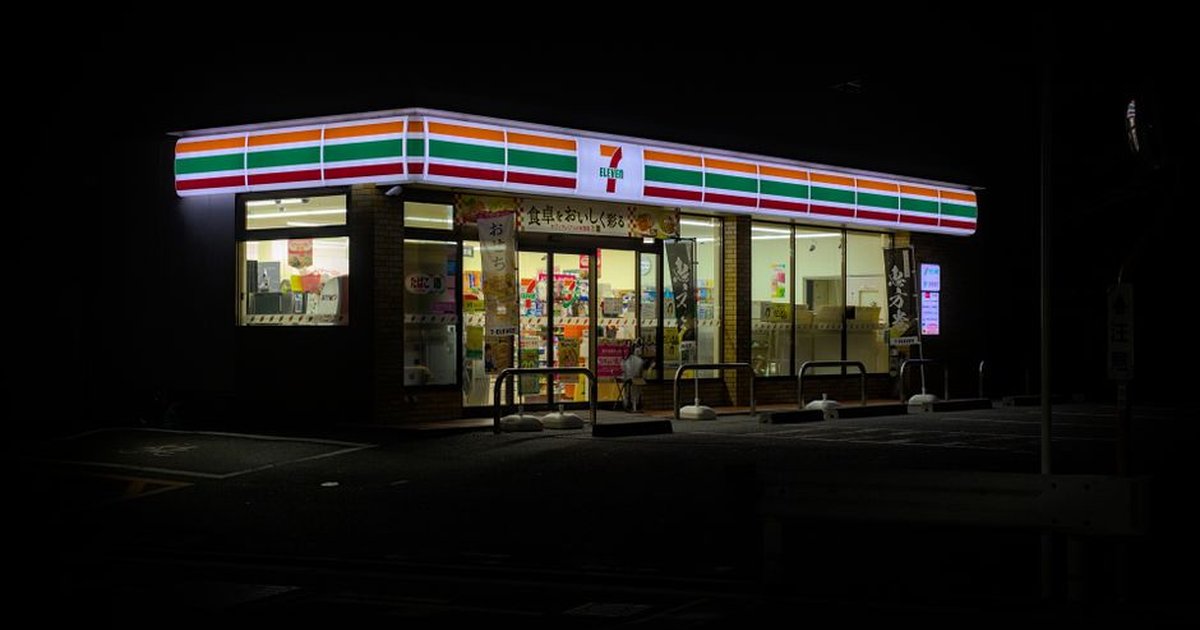 Illuminated 7-Eleven in Kyoto, Japan at night, showcasing a classic convenience store ambiance.