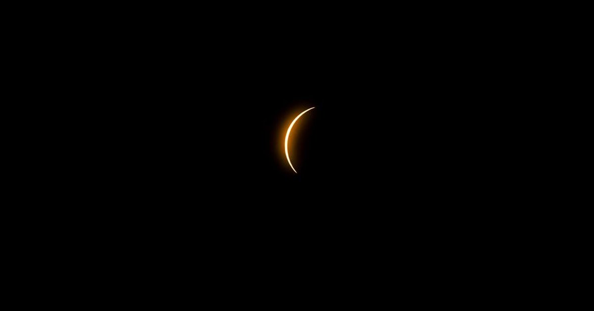 Captivating crescent solar eclipse photographed against the dark night sky in Mazatlán, México.