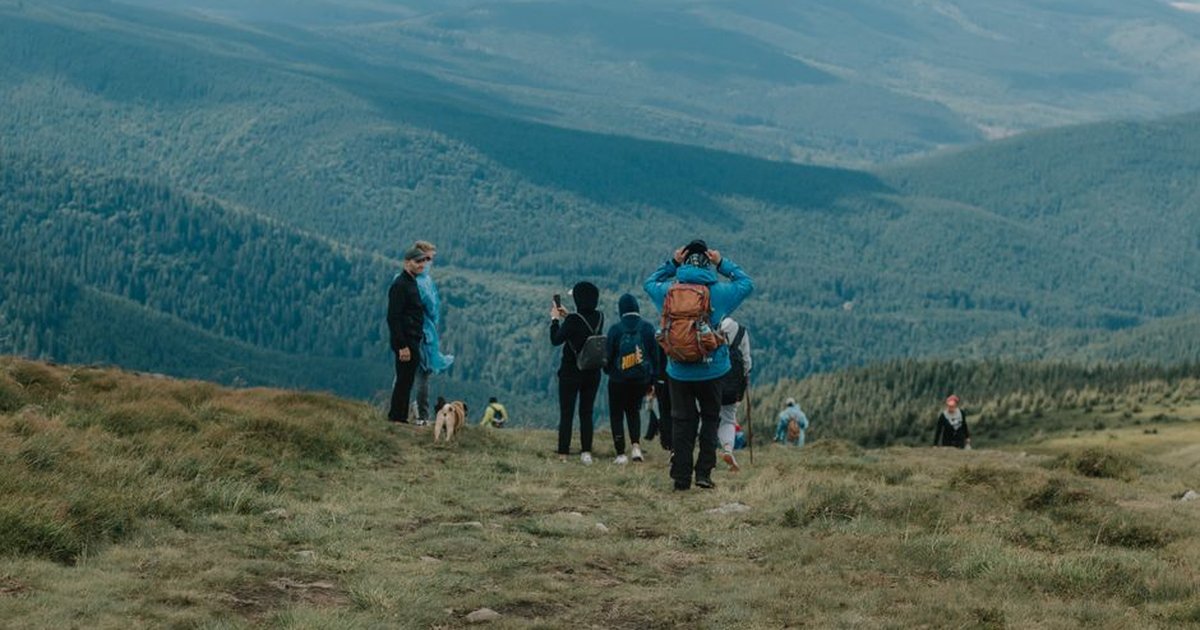 Enthusiastic hikers enjoying a scenic mountain trek with breathtaking views.