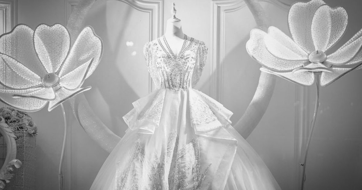 Stunning wedding dress with floral decorations in an elegant setting, ideal for bridal themes.