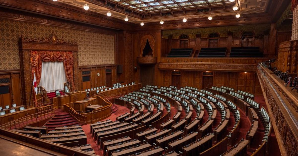 Captivating wide-angle view of a classic legislative assembly hall with ornate wood design.