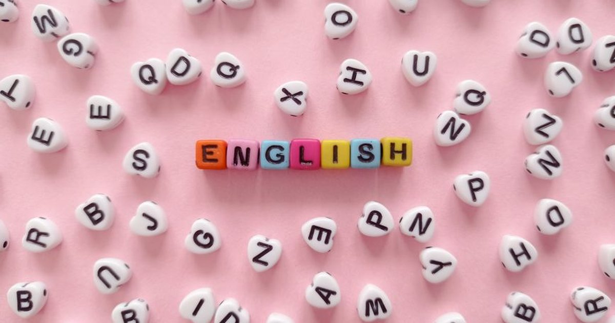 Scattered letter beads form the word 'English' on a pink background, symbolizing language learning.