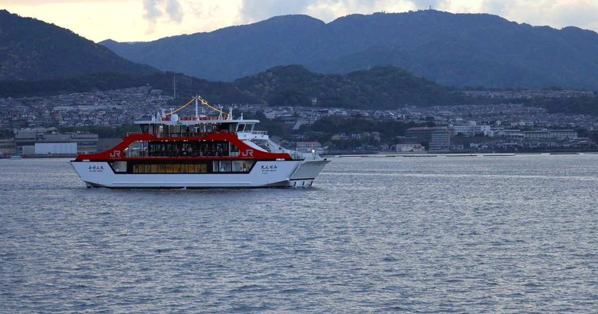 Scenic view of a JR West ferry cruising near Miyajima, Hiroshima during sunset.
