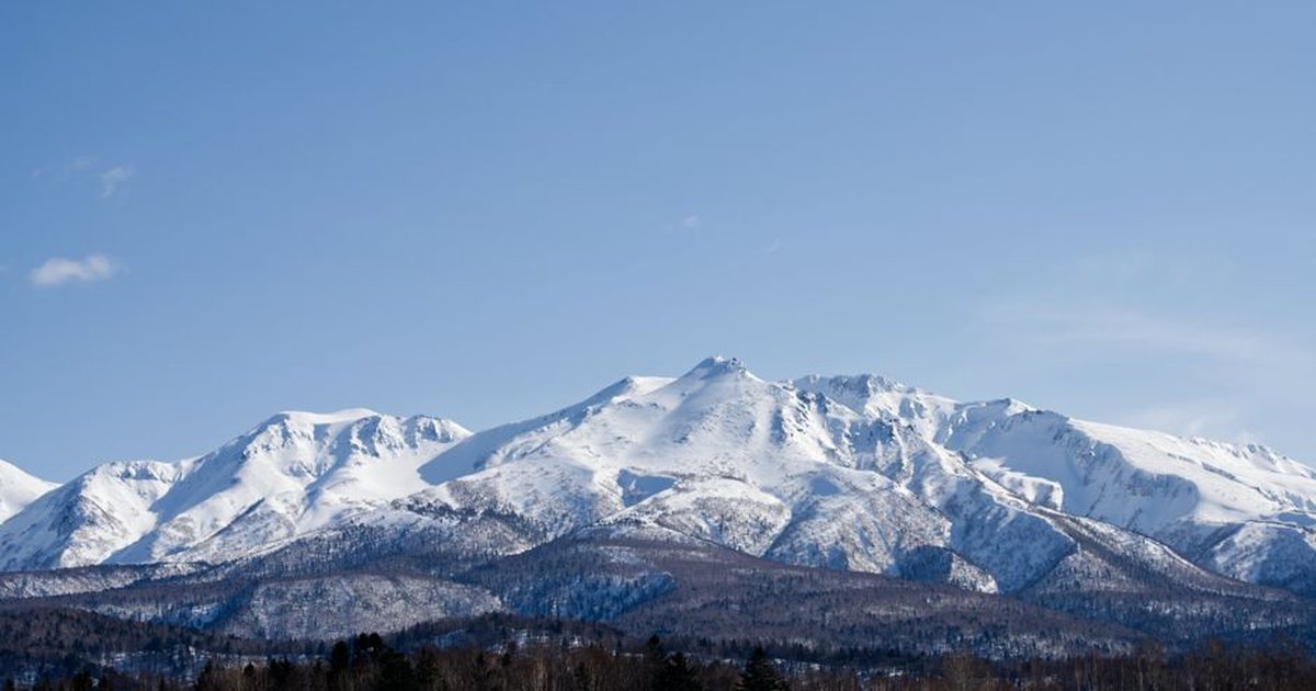 Majestic snowcapped mountains in Hokkaido under a clear blue sky, perfect for travel inspiration.